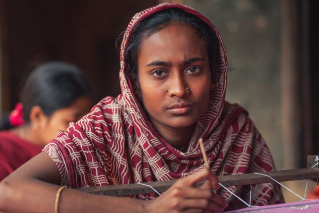Portrait of a Bangladeshi weaver engaged in traditional craftsmanship, showcasing local culture.
